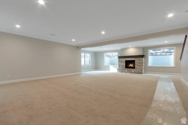 15724 S Rolling Bluff Dr, Draper Ut Cnty, UT 84020 - unfurnished living room featuring baseboards, light carpet, a stone fireplace, recessed lighting, and beamed ceiling