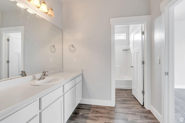 108 W Seasons Dr, Vineyard, UT 84059 - full bathroom featuring wood finished floors, vanity, baseboards, and shower / washtub combination