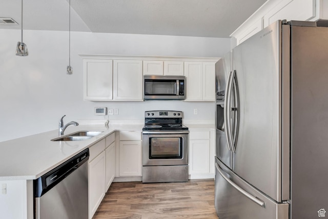108 W Seasons Dr, Vineyard, UT 84059 - kitchen with light countertops, light wood-style floors, visible vents, stainless steel appliances, and a sink
