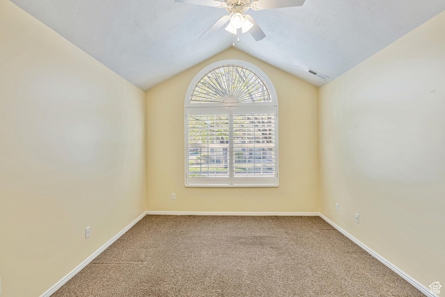 unfurnished room featuring visible vents, baseboards, ceiling fan, carpet floors, and lofted ceiling