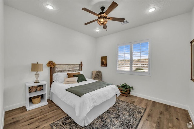 bedroom with ceiling fan, visible vents, recessed lighting, wood finished floors, and baseboards