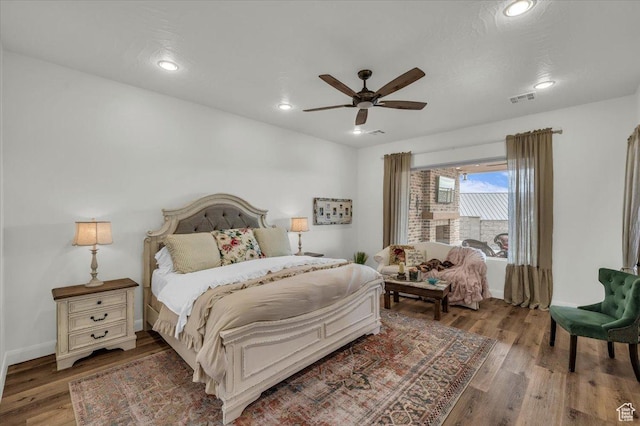 bedroom featuring wood finished floors, a ceiling fan, visible vents, and recessed lighting