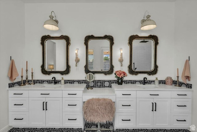 bathroom featuring two vanities and a sink