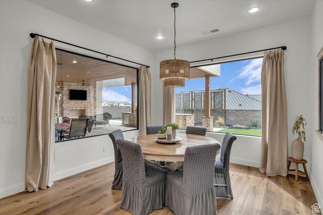 dining area with visible vents, a wealth of natural light, and light wood-type flooring