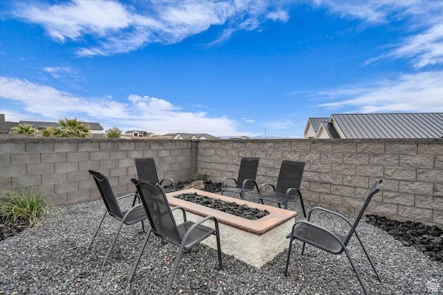 view of patio featuring fence and an outdoor fire pit