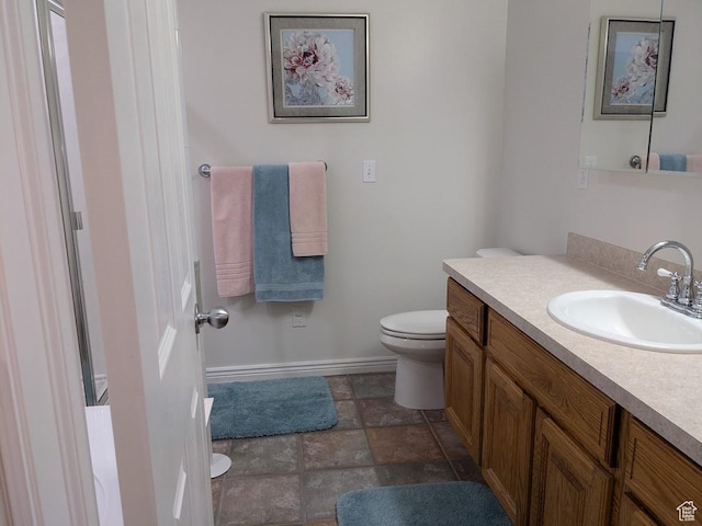 641 W 3550 S, Riverdale, UT 84405 - bathroom featuring toilet, baseboards, stone finish floor, and vanity