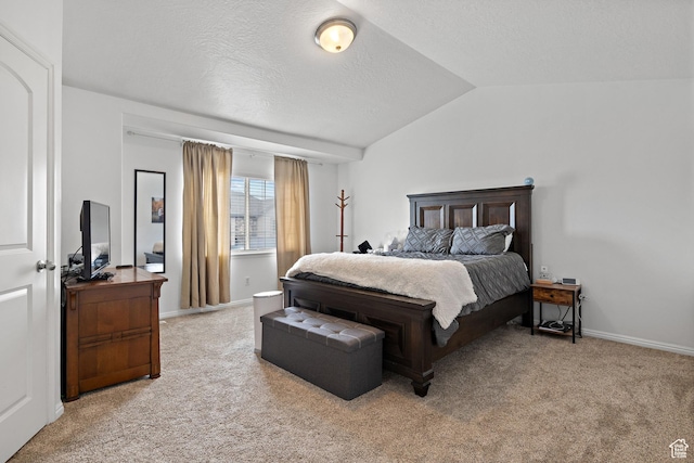 carpeted bedroom with a textured ceiling, baseboards, and lofted ceiling