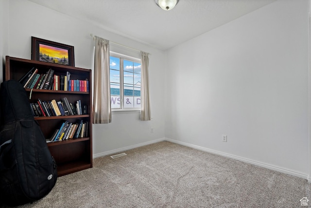 spare room with visible vents, baseboards, and carpet floors