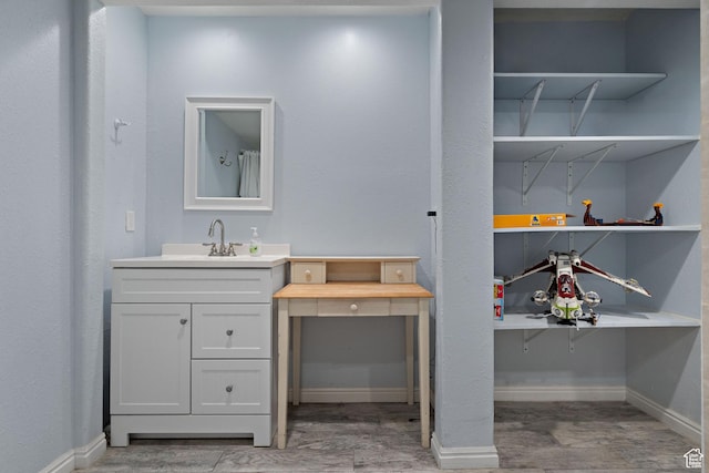 full bath with vanity, baseboards, and wood finished floors