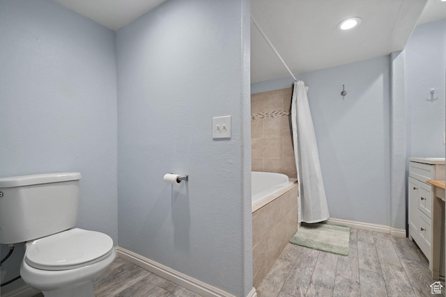 bathroom featuring toilet, vanity, baseboards, and wood tiled floor
