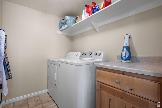 laundry area featuring baseboards, separate washer and dryer, and laundry area