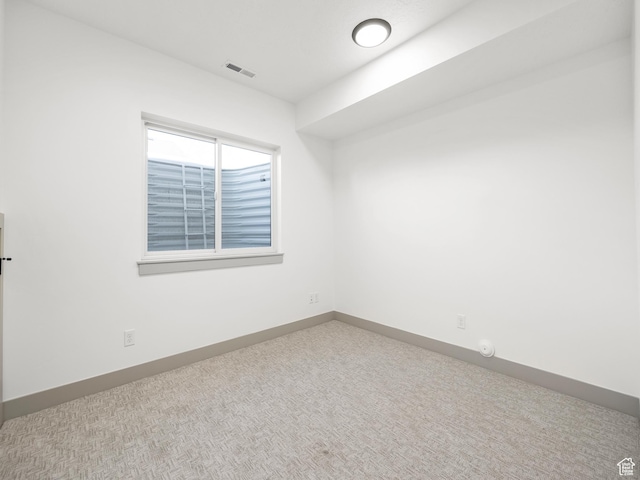 empty room featuring visible vents, baseboards, and carpet flooring