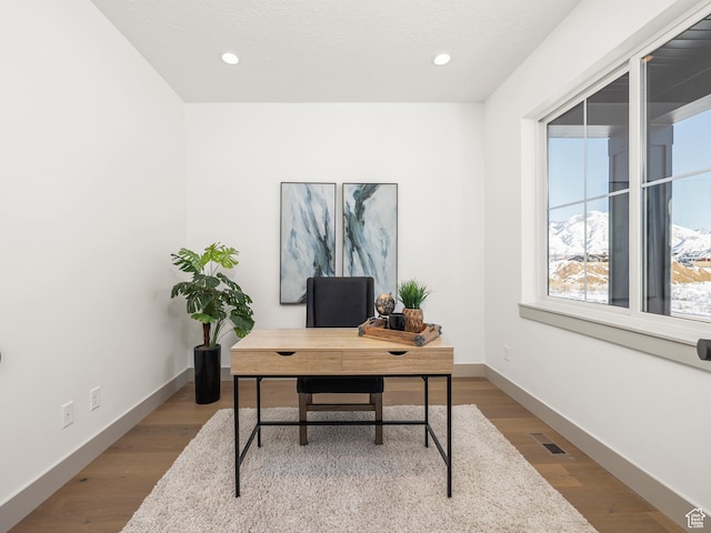 home office with visible vents, baseboards, recessed lighting, and wood finished floors