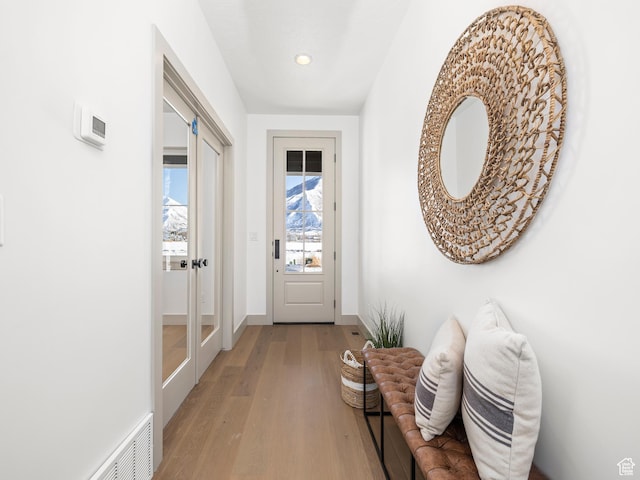 entryway with visible vents, baseboards, recessed lighting, and wood finished floors