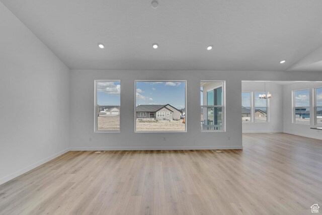 356 W Emma St Unit 625, Grantsville, UT 84029 - unfurnished living room featuring light wood-style floors, an inviting chandelier, and plenty of natural light