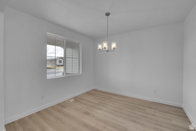 356 W Emma St Unit 625, Grantsville, UT 84029 - unfurnished dining area featuring visible vents, baseboards, light wood finished floors, and a notable chandelier