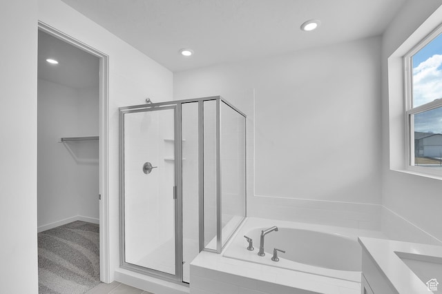 356 W Emma St Unit 625, Grantsville, UT 84029 - full bathroom with a spacious closet, recessed lighting, a bath, and a stall shower