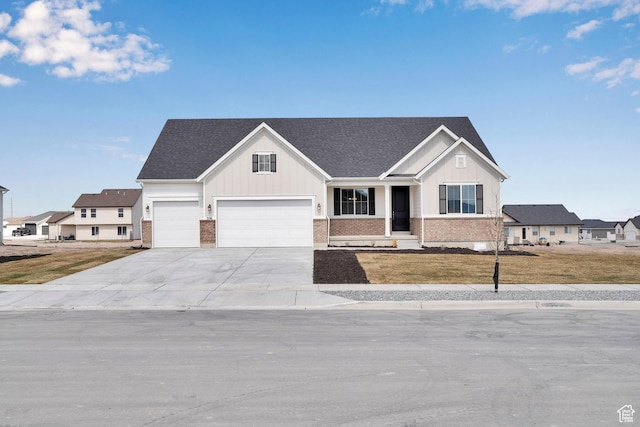 356 W Emma St Unit 625, Grantsville, UT 84029 - view of front of house with concrete driveway, board and batten siding, a front lawn, an attached garage, and brick siding