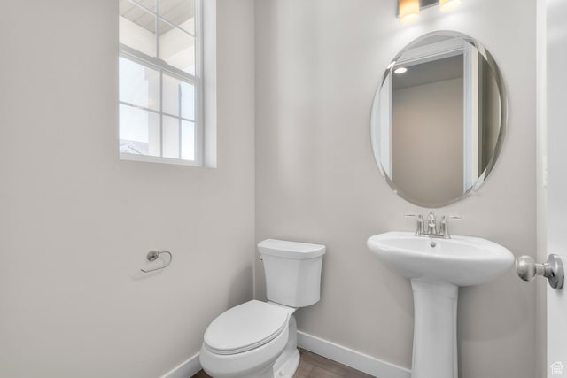 6633 N Price, Eagle Mountain, UT 84005 - bathroom featuring toilet, wood finished floors, a sink, and baseboards