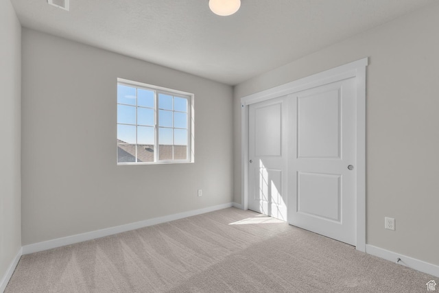 6633 N Price, Eagle Mountain, UT 84005 - unfurnished bedroom featuring a closet, carpet, and baseboards