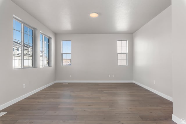 6633 N Price, Eagle Mountain, UT 84005 - unfurnished room with baseboards and wood finished floors