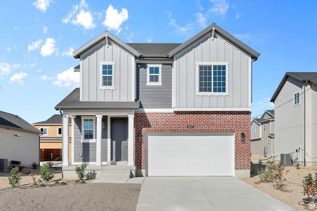 view of front of house with concrete driveway, central AC unit, board and batten siding, and an attached garage