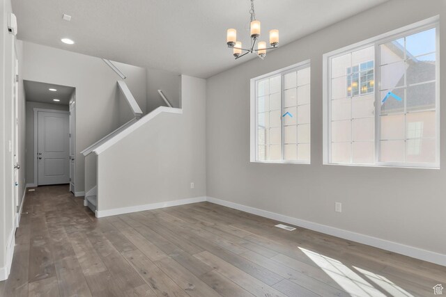 6633 N Price, Eagle Mountain, UT 84005 - interior space featuring baseboards, a wealth of natural light, a notable chandelier, and wood finished floors