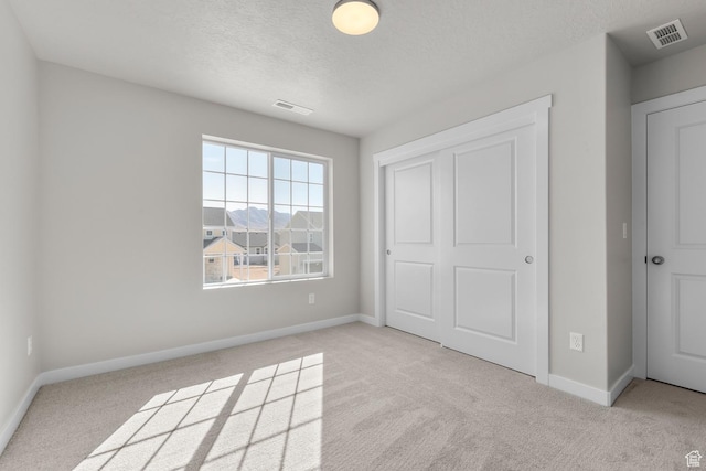 6633 N Price, Eagle Mountain, UT 84005 - unfurnished bedroom featuring visible vents, baseboards, and a textured ceiling