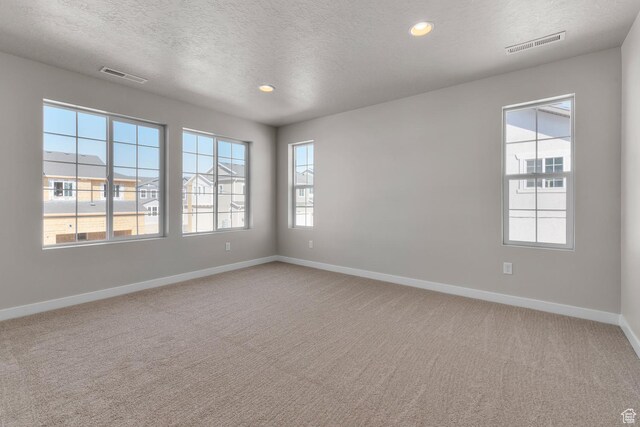 6633 N Price, Eagle Mountain, UT 84005 - empty room featuring visible vents, baseboards, and light colored carpet
