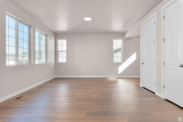 6624 W Prairie Fire Ln, Herriman, UT 84096 - spare room with visible vents, baseboards, wood finished floors, and a textured ceiling