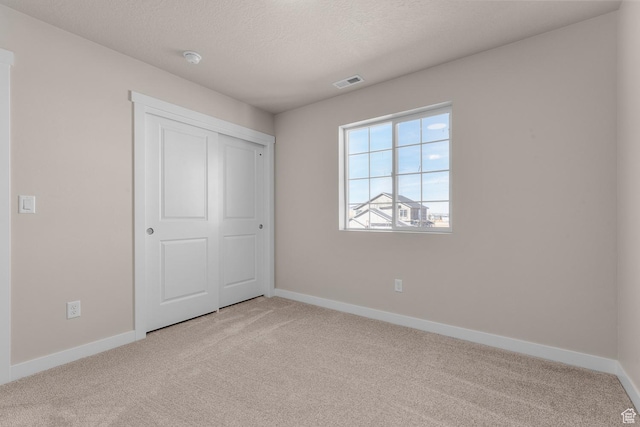 6624 W Prairie Fire Ln, Herriman, UT 84096 - unfurnished bedroom featuring visible vents, baseboards, a textured ceiling, and carpet floors