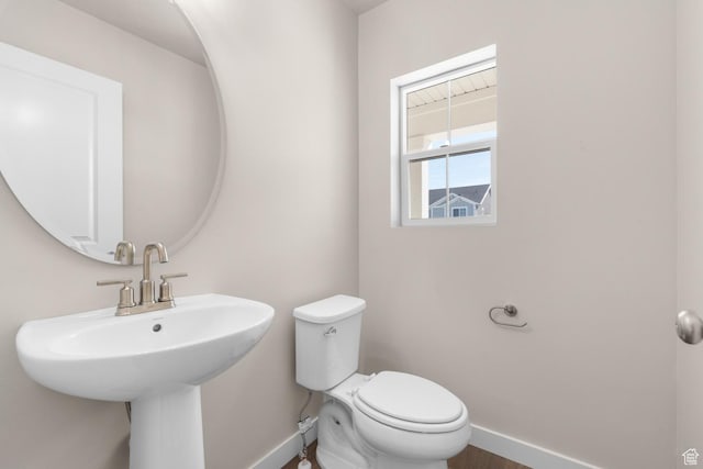 6624 W Prairie Fire Ln, Herriman, UT 84096 - half bathroom featuring a sink, toilet, and baseboards