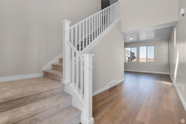 6624 W Prairie Fire Ln, Herriman, UT 84096 - staircase with visible vents, wood-type flooring, and baseboards