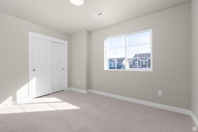 6658 W Spring Snow Ln, Herriman, UT 84096 - unfurnished bedroom featuring visible vents, baseboards, carpet flooring, and a closet