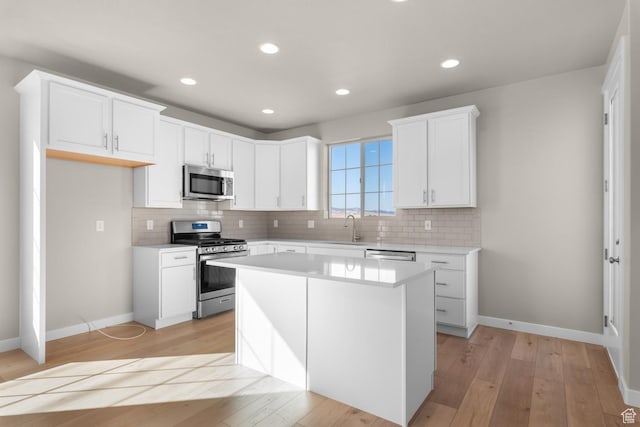 6658 W Spring Snow Ln, Herriman, UT 84096 - kitchen featuring stainless steel appliances, light countertops, a sink, and decorative backsplash