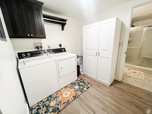 2770 S 9500 E, Jensen, UT 84035 - clothes washing area featuring light wood-style flooring, washing machine and clothes dryer, and cabinet space
