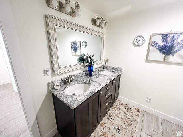 2770 S 9500 E, Jensen, UT 84035 - bathroom with wood finished floors, double vanity, a sink, and baseboards