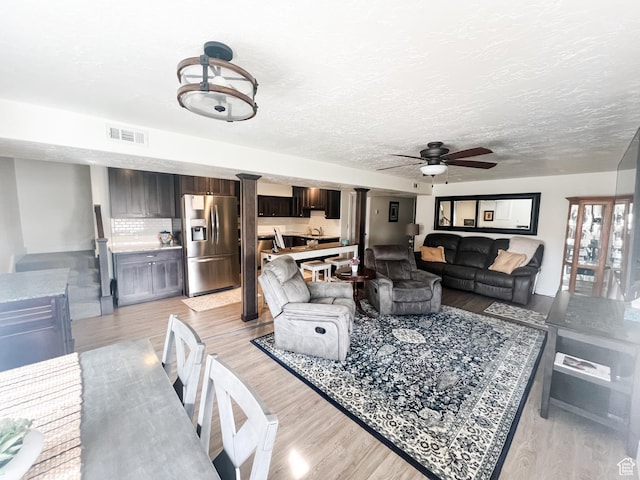 2770 S 9500 E, Jensen, UT 84035 - living area with light wood-style floors, ceiling fan, visible vents, and a textured ceiling