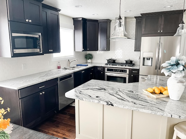 2770 S 9500 E, Jensen, UT 84035 - kitchen with wall chimney exhaust hood, a sink, dark wood finished floors, stainless steel appliances, and light stone counters