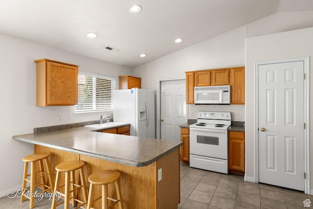1360 E Telegraph St # 8, Washington, UT 84780 - kitchen with visible vents, white appliances, a kitchen breakfast bar, a peninsula, and vaulted ceiling