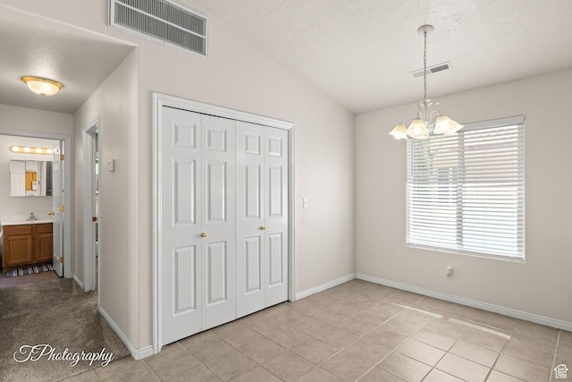 1360 E Telegraph St # 8, Washington, UT 84780 - unfurnished dining area with baseboards, a sink, a notable chandelier, and visible vents