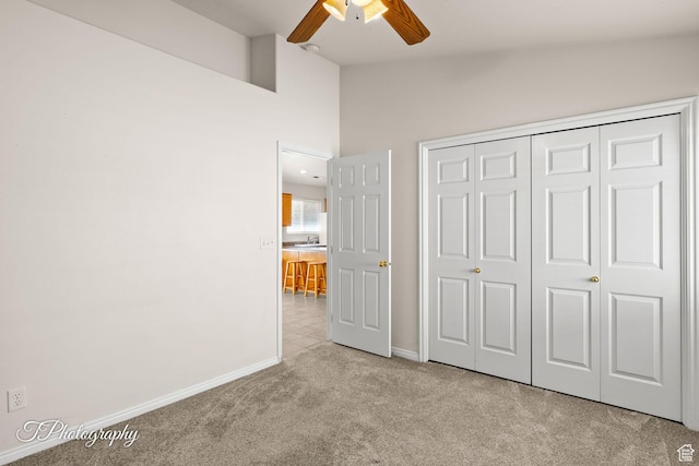 1360 E Telegraph St # 8, Washington, UT 84780 - unfurnished bedroom with a closet, baseboards, a ceiling fan, vaulted ceiling, and carpet flooring