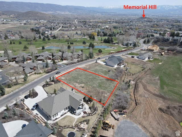 birds eye view of property with a water and mountain view and a residential view