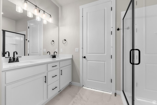 bathroom with baseboards, a sink, a shower stall, double vanity, and marble finish floor