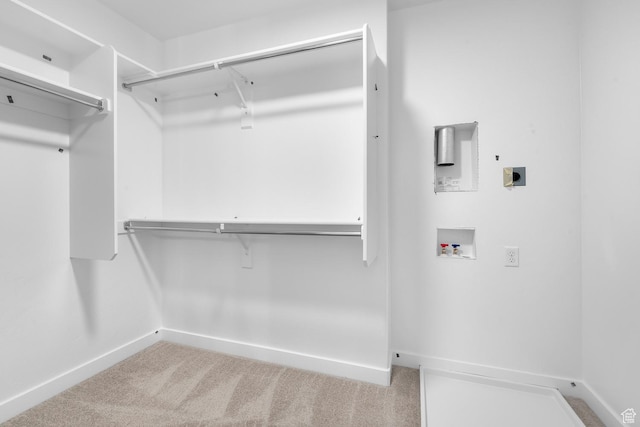 walk in closet featuring carpet flooring