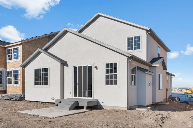 back of house with stucco siding