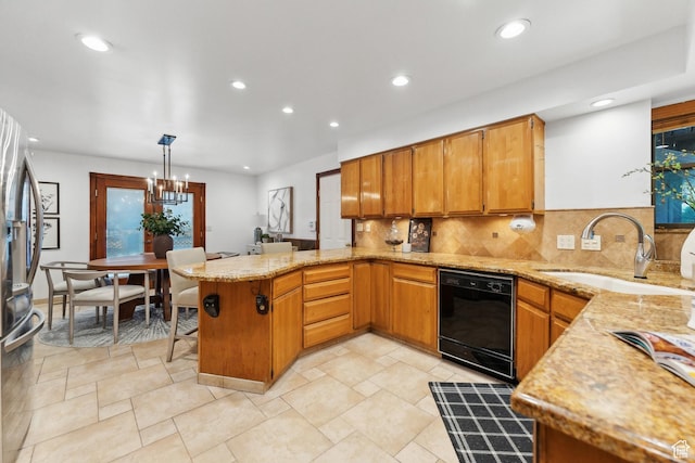 kitchen featuring a peninsula, dishwasher, a sink, a notable chandelier, and backsplash