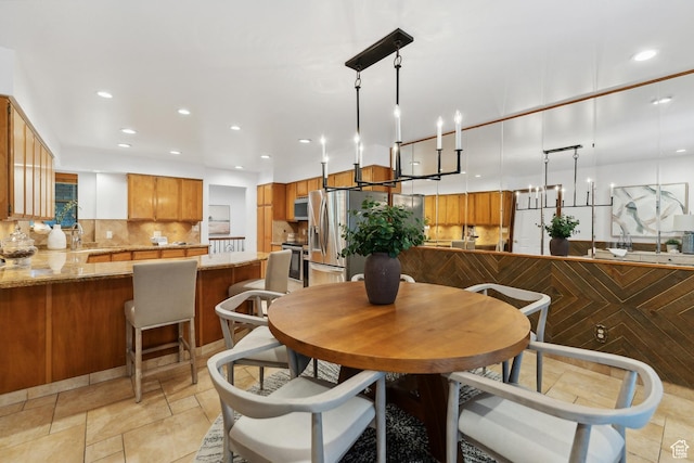 dining room featuring stone finish floor and recessed lighting
