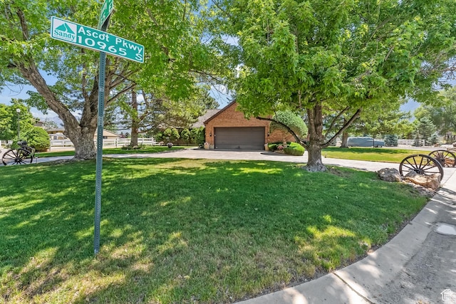 exterior space with a garage, a front lawn, and brick siding