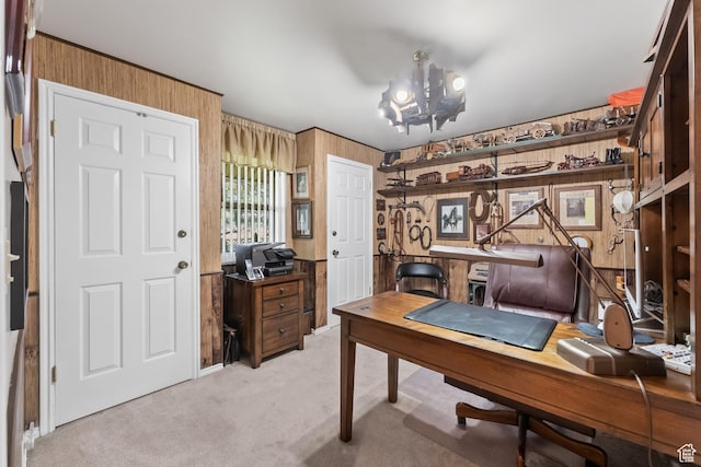 home office with light carpet, wood walls, and a notable chandelier